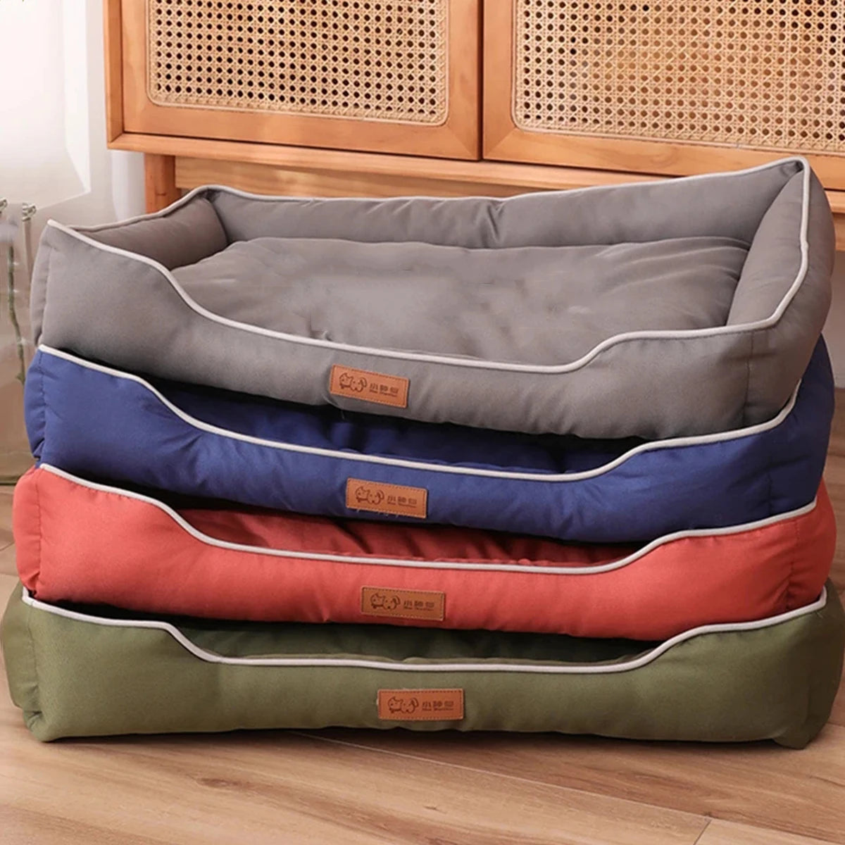 Four-Season Sofa Dog Bed stacked in grey, blue, red and green