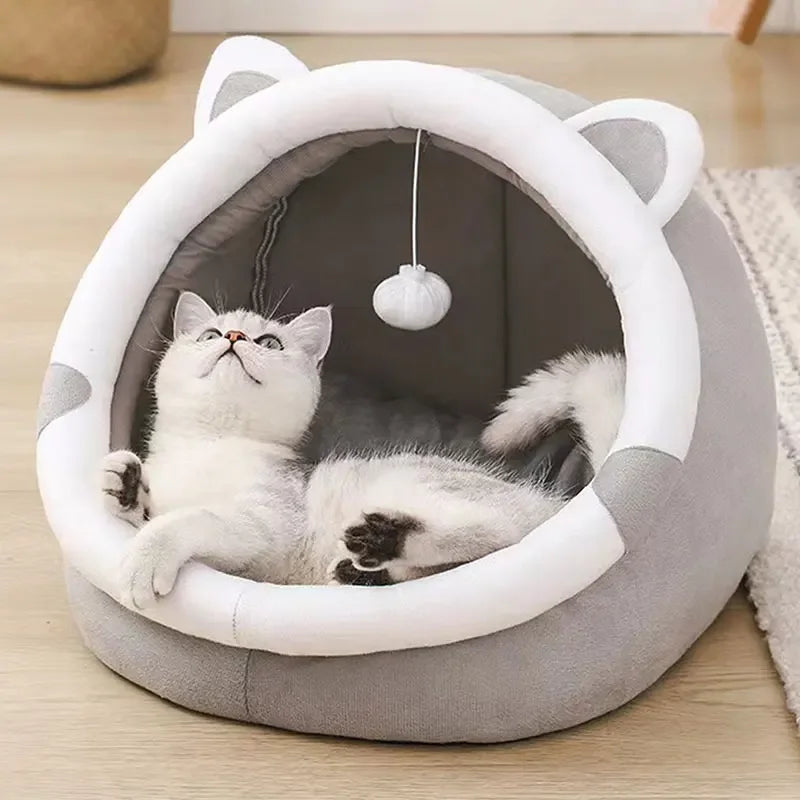 Cat curled up inside the Self-Warming Cat Cave