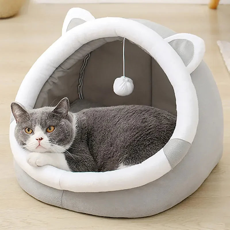 Grey cat resting in the Self-Warming Cat Cave